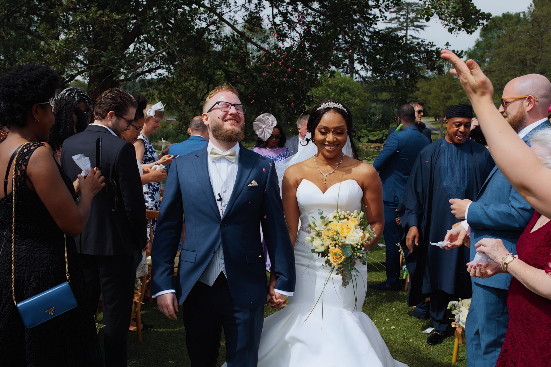 Newlyweds walking through a confetti shower after their ceremony